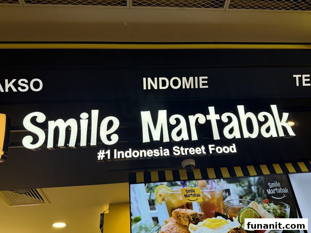 The image displays the illuminated 'Smile Martabak' sign, promoting '#1 Indonesia Street Food' with a vibrant food display below.