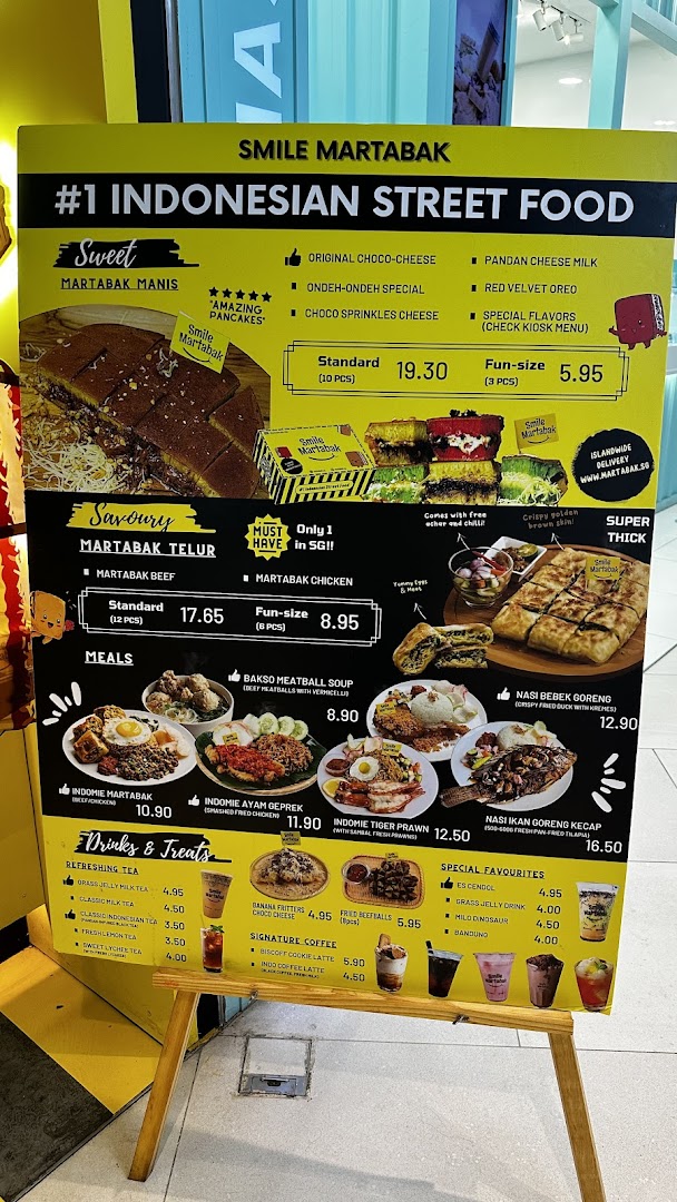 A vibrant yellow menu board for Smile Martabak, showcasing sweet and savoury Indonesian street food.
