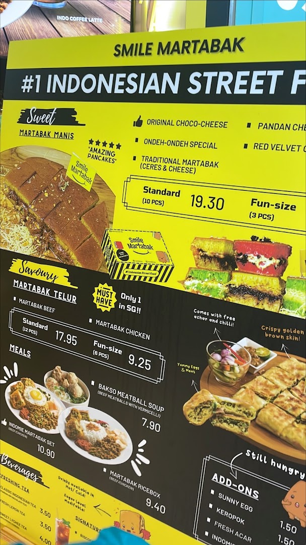 A vibrant yellow and black menu board displaying Indonesian street food, including sweet and savoury martabak.