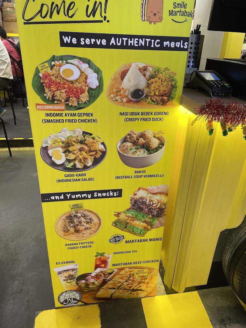 A vibrant yellow menu board showcasing authentic Indonesian meals and yummy snacks from Smile Martabak.