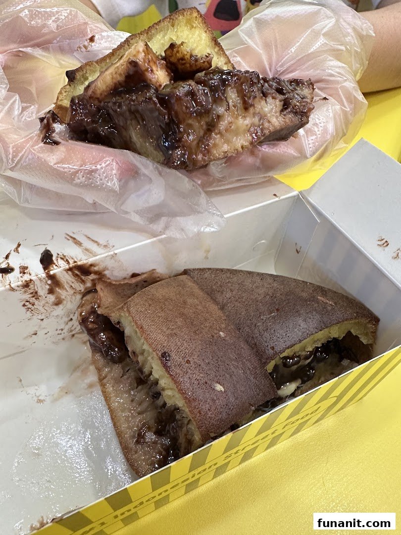 Delicious chocolate martabak being enjoyed, with another piece in a takeaway box.