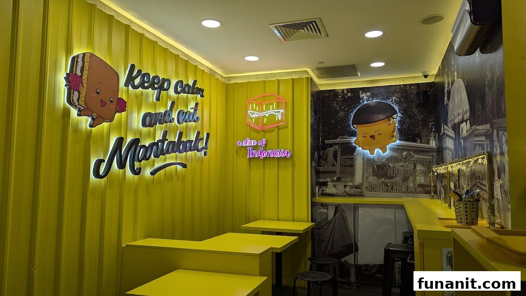 A vibrant interior of Smile Martabak featuring bright yellow walls, playful neon signs, and Indonesian-themed decor.