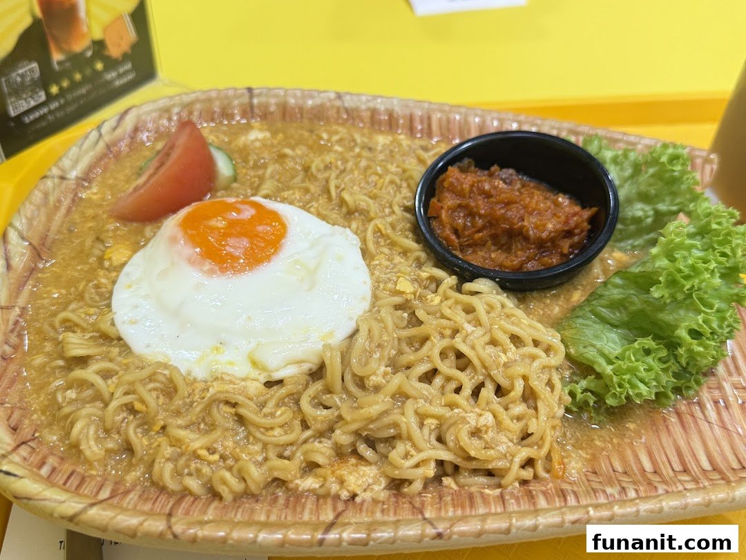 A close-up of delicious noodles topped with a fried egg, chili, and fresh lettuce.