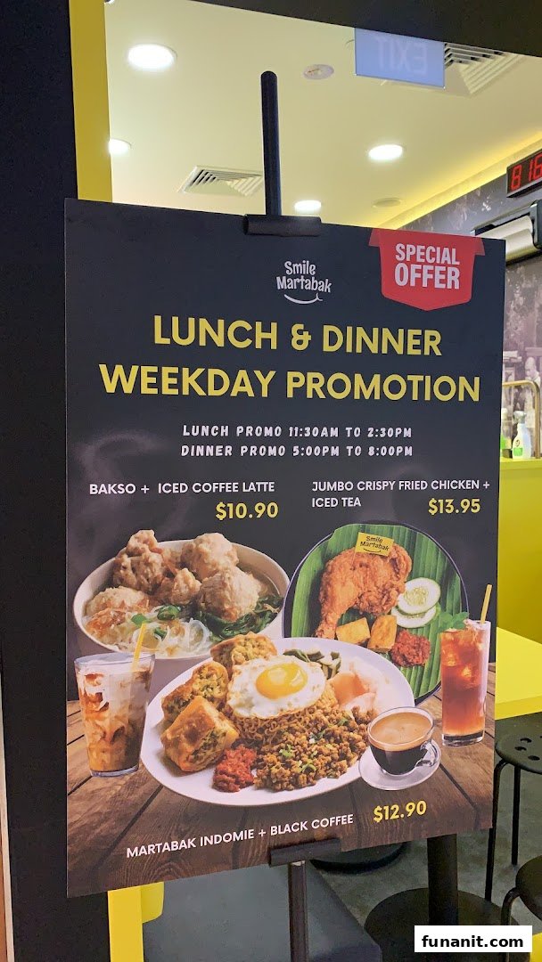 A promotional stand displaying Smile Martabak's weekday lunch and dinner promotions with food images.