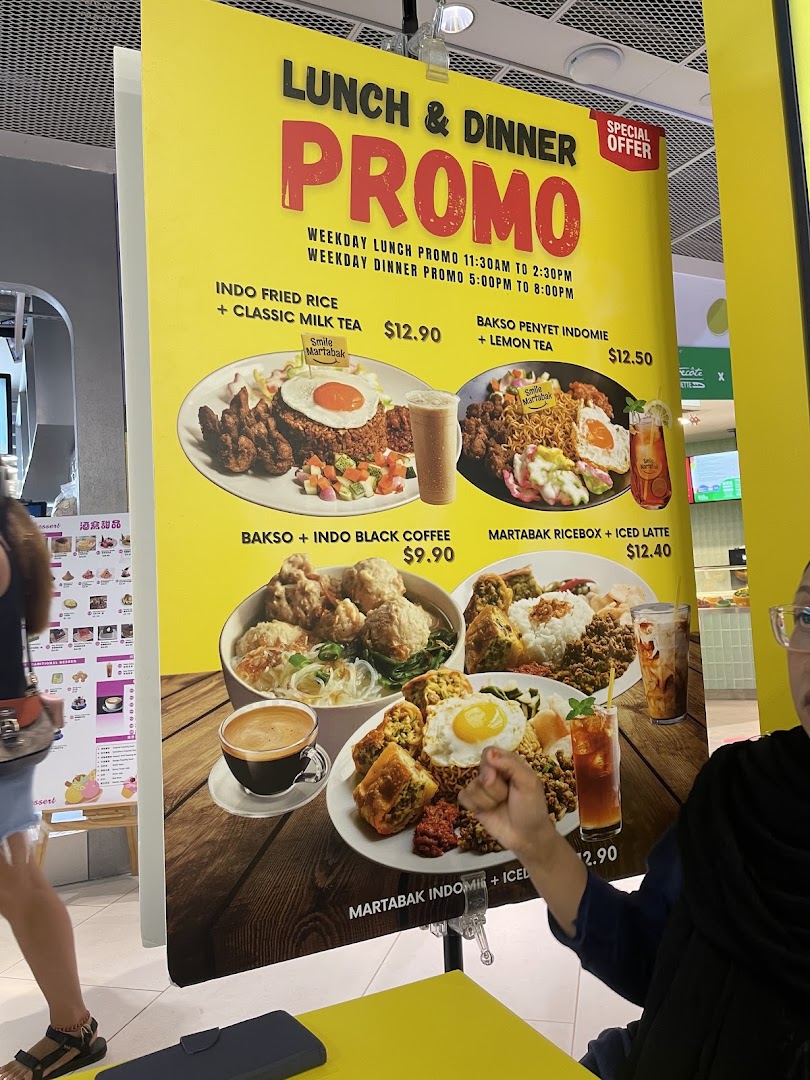 A large yellow promotional banner displaying Smile Martabak's lunch and dinner set menus with prices and food images.
