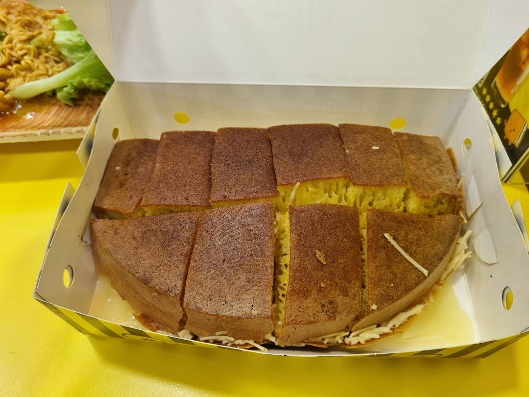 A box of freshly sliced martabak, a sweet Indonesian pancake, with visible toppings.