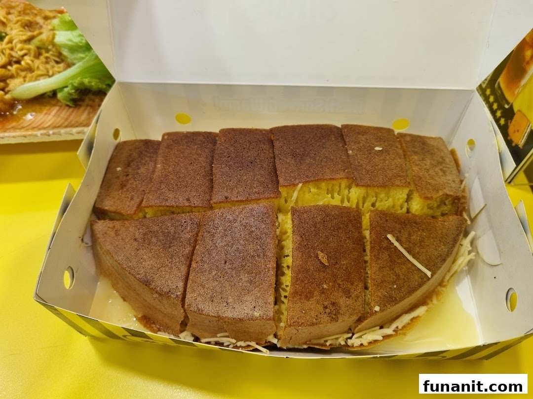 A box of freshly sliced martabak, a sweet Indonesian pancake, with visible toppings.