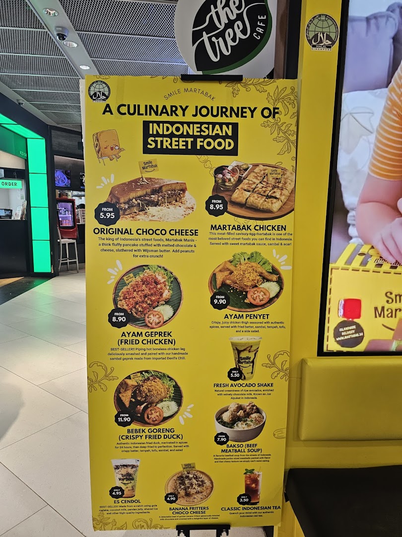 A large yellow menu board for Smile Martabak, showcasing Indonesian street food dishes and drinks.