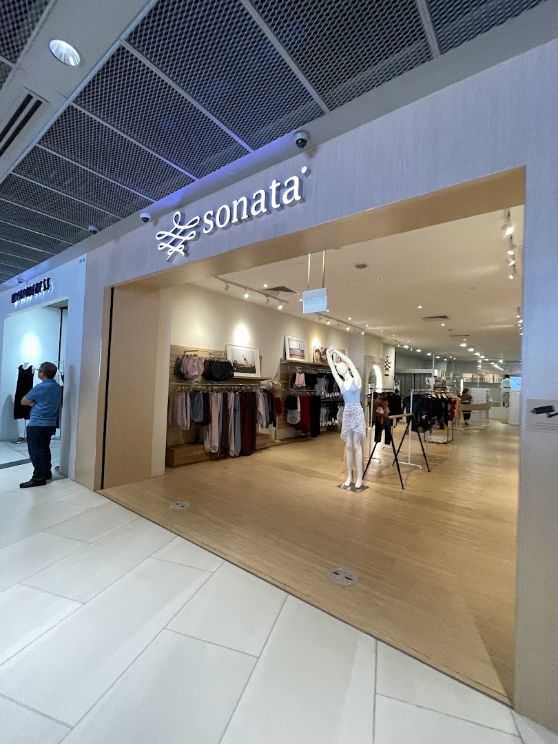 The inviting entrance of the Sonata Flagship Store showcasing its stylish apparel and a mannequin.