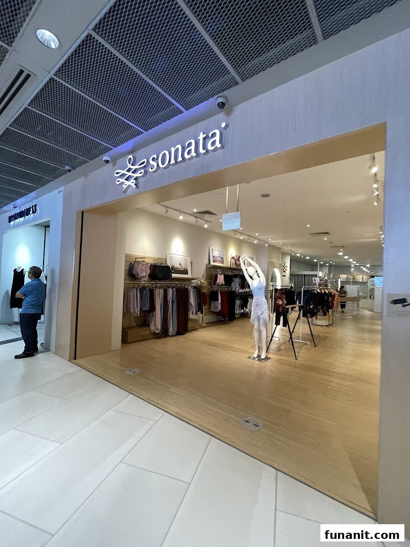 The inviting entrance of the Sonata Flagship Store showcasing its stylish apparel and a mannequin.