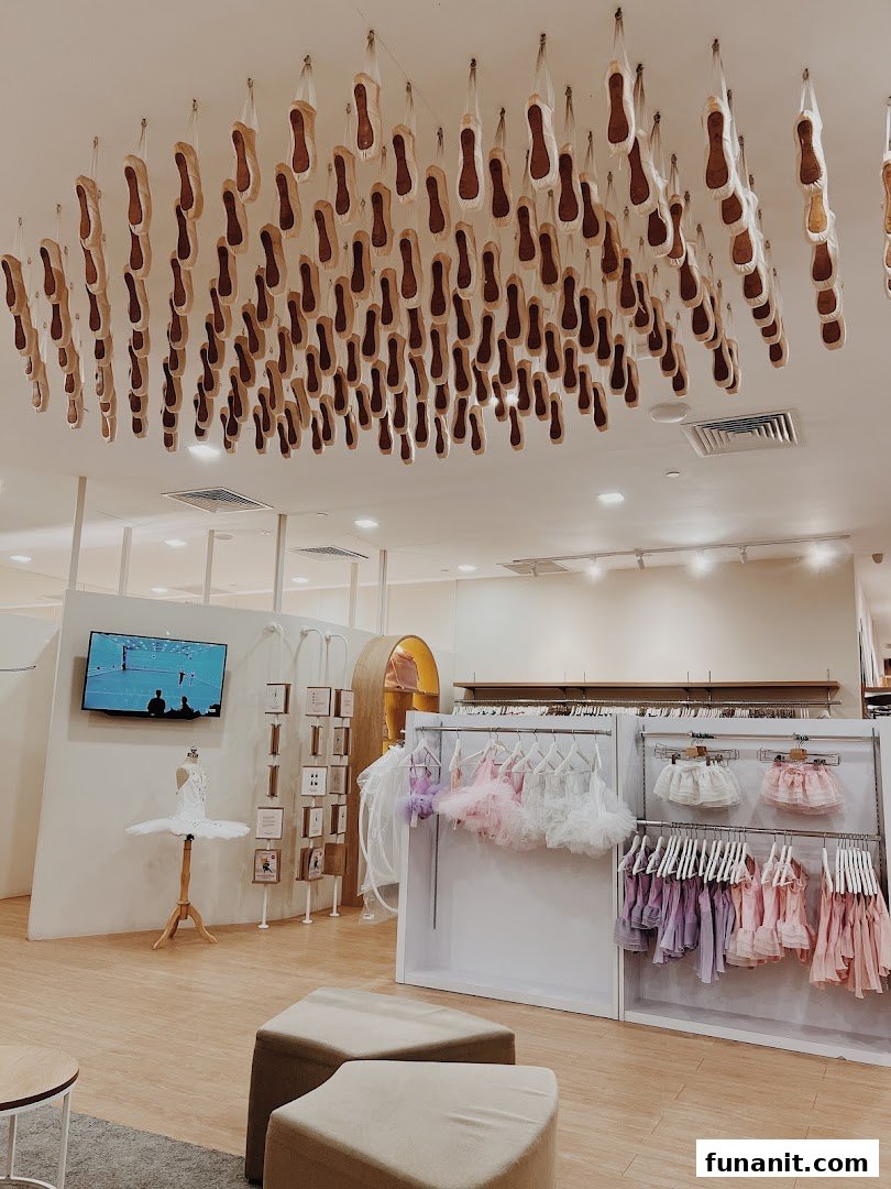 Interior of Sonata Flagship Store featuring ballet shoes on the ceiling, dancewear, and a tutu mannequin.