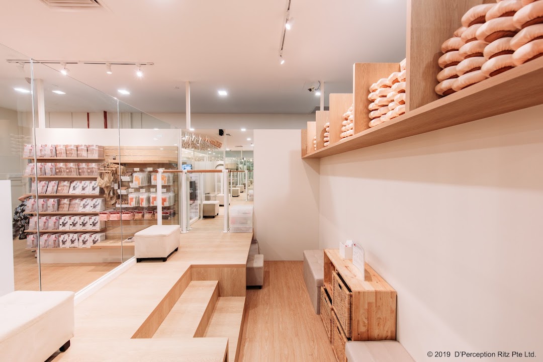 Bright, modern interior of a dancewear shop featuring ballet shoes, apparel, and seating areas.