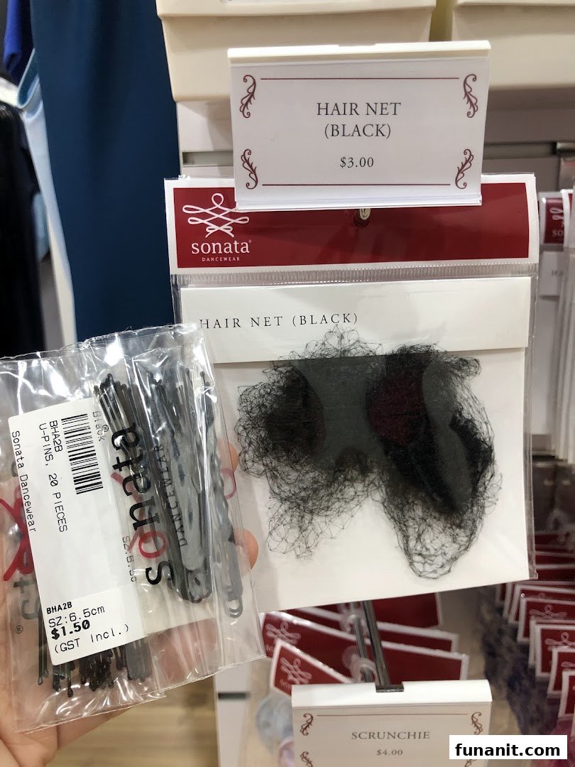 Close-up of Sonata Dancewear hair accessories including hair nets, U-pins, and scrunchies with price tags.