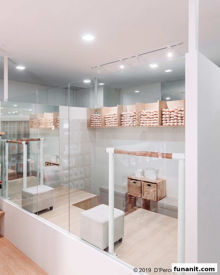 Interior view of a ballet shop featuring pointe shoes on display and a ballet barre.