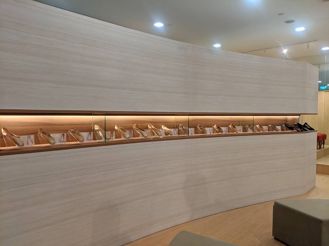 An elegant display of ballet slippers and shoes in a well-lit, modern retail interior.