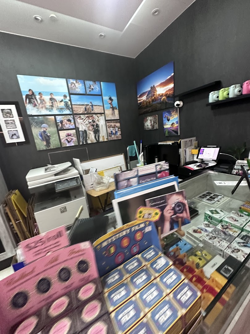 Interior of a photo shop displaying prints, cameras, and film products.