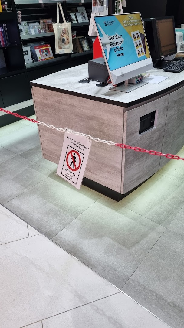 Interior view of Standard Photo Funan counter, showing passport photo services and a 'No Entry' sign.