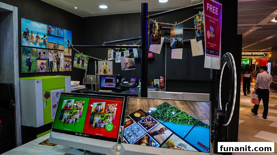 Interior of Standard Photo Funan, showcasing self-service photo printing kiosks, sample prints, and a service counter.
