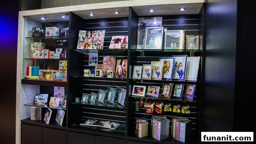 Display shelves showcasing instant cameras, photo frames, custom photo products, and albums at Standard Photo Funan.