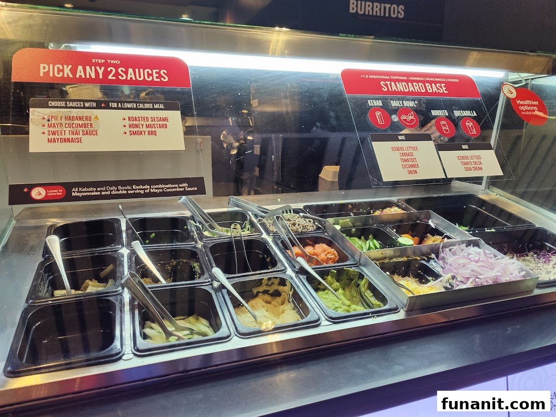 A vibrant food counter showcasing fresh ingredients and clear menu options for custom-built meals at Stuffd.