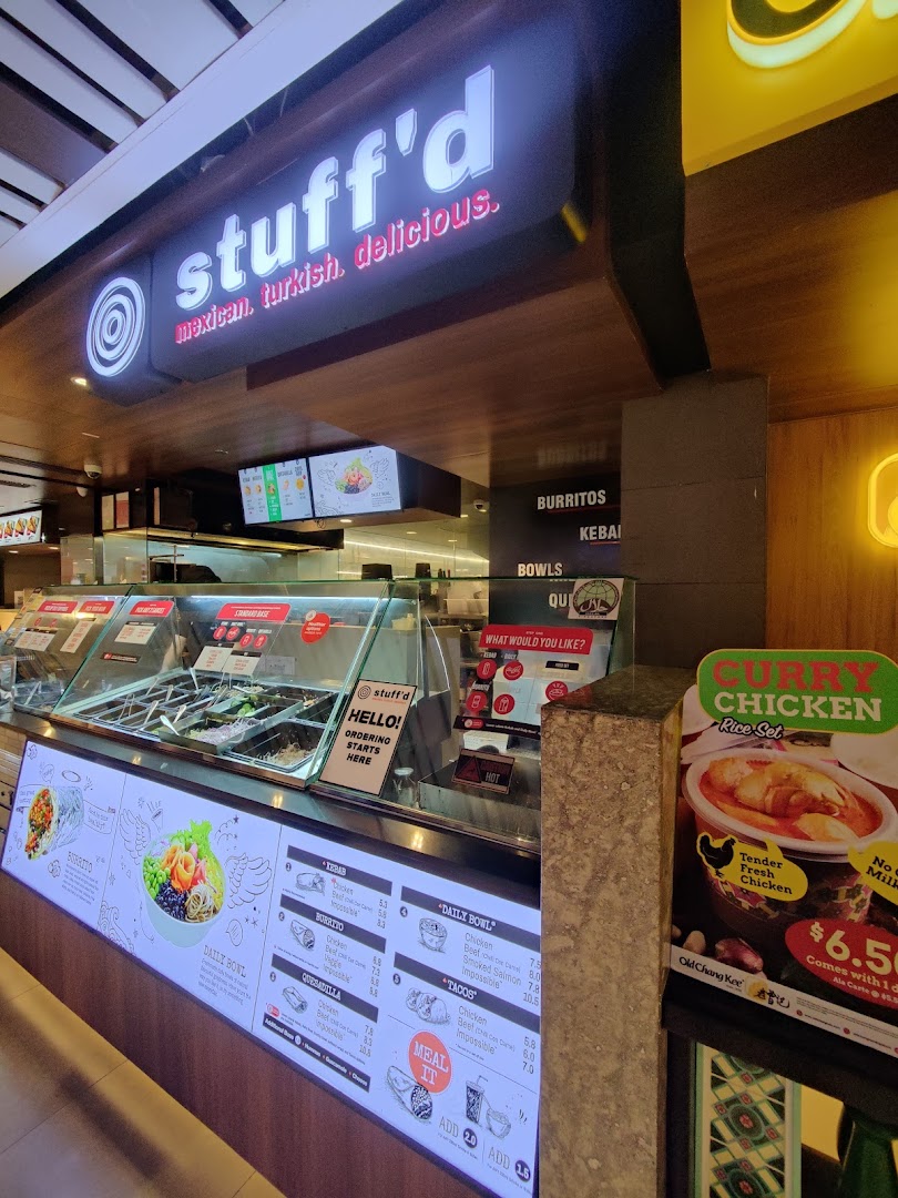A vibrant counter view of Stuffd, showcasing its digital menu with customizable Mexican and Turkish dishes.