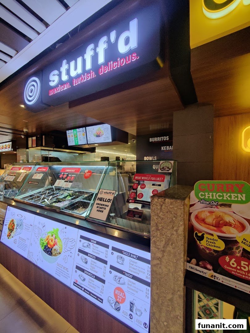 A vibrant counter view of Stuffd, showcasing its digital menu with customizable Mexican and Turkish dishes.