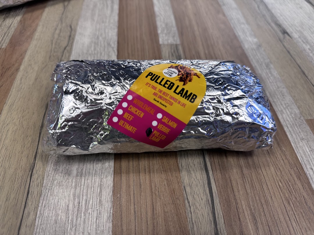 A foil-wrapped food item from Stuffd with a 'Pulled Lamb' label, featuring various filling options.