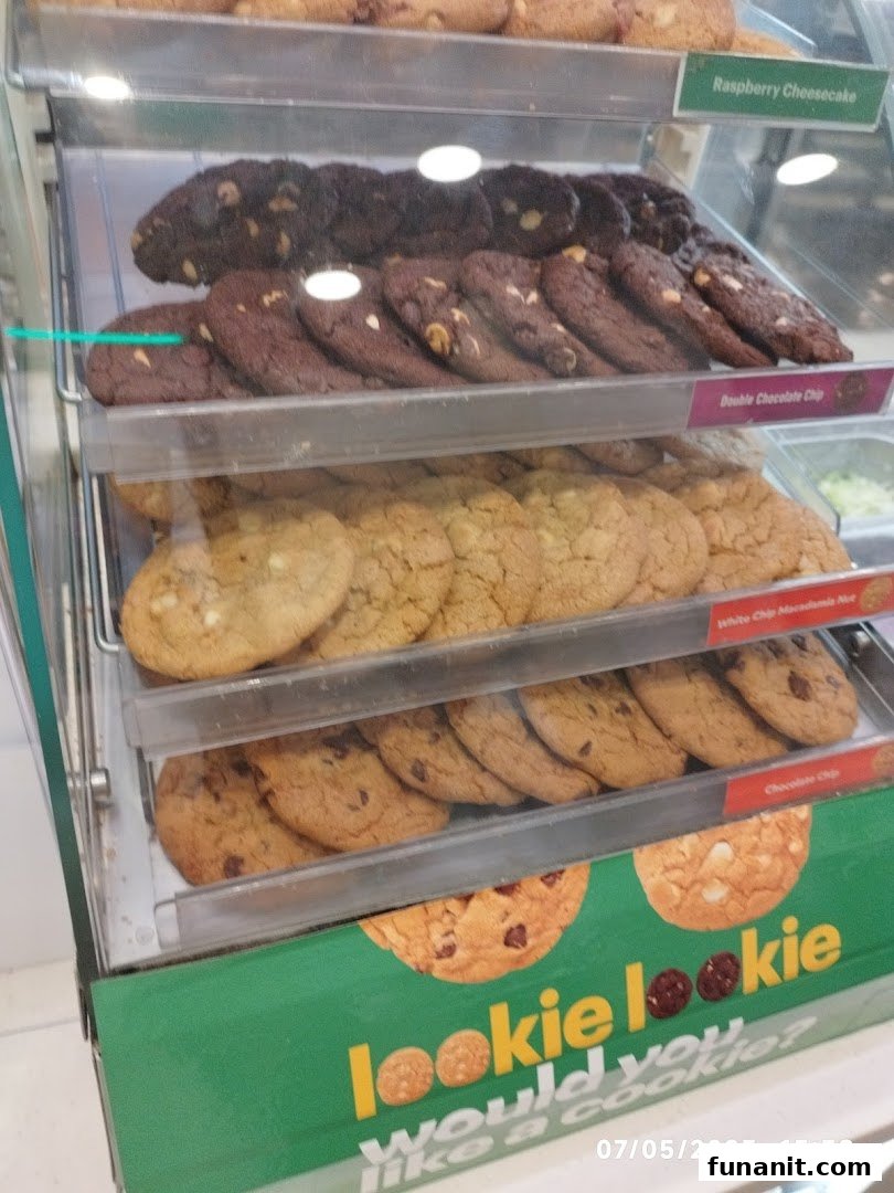 A vibrant display case showcasing a variety of freshly baked cookies at Subway.