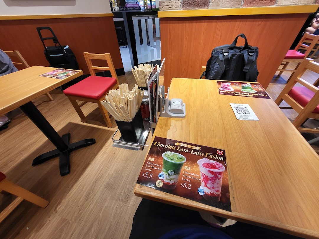An interior shot of Sukiya Gyudon & Curry Funan, showing a dining table with promotional flyers.
