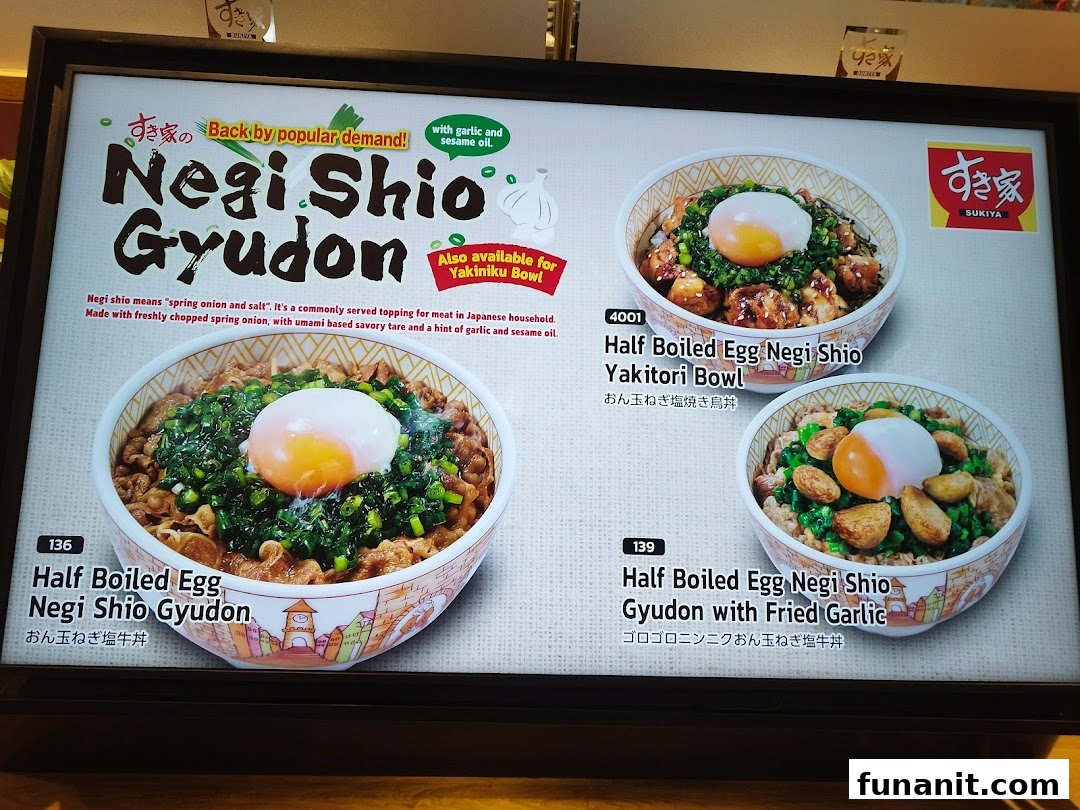 A Sukiya menu board showcasing Negi Shio Gyudon and other specialty bowls with eggs and toppings.