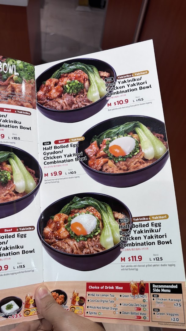 A close-up view of a Sukiya menu displaying various gyudon and yakitori combination bowls, drinks, and side dishes.