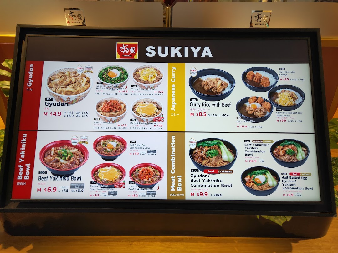 A brightly lit menu board displaying various Japanese dishes from Sukiya.
