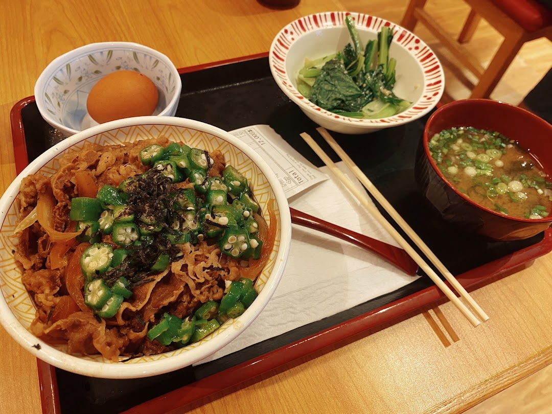 A delicious Sukiya Gyudon meal set with beef bowl, side dishes, and miso soup.