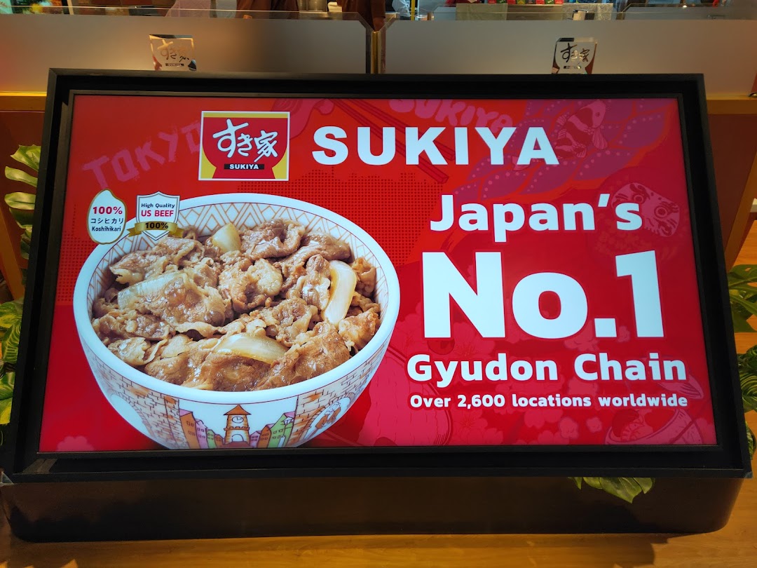 A promotional display for Sukiya featuring a gyudon bowl and highlighting its status as Japan's No.1 Gyudon Chain.