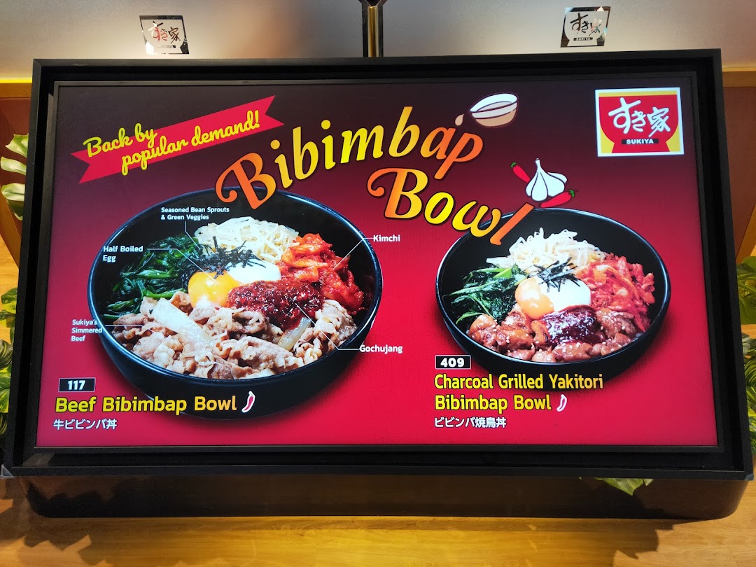 A digital menu board at Sukiya showcasing two types of Bibimbap bowls with their ingredients.