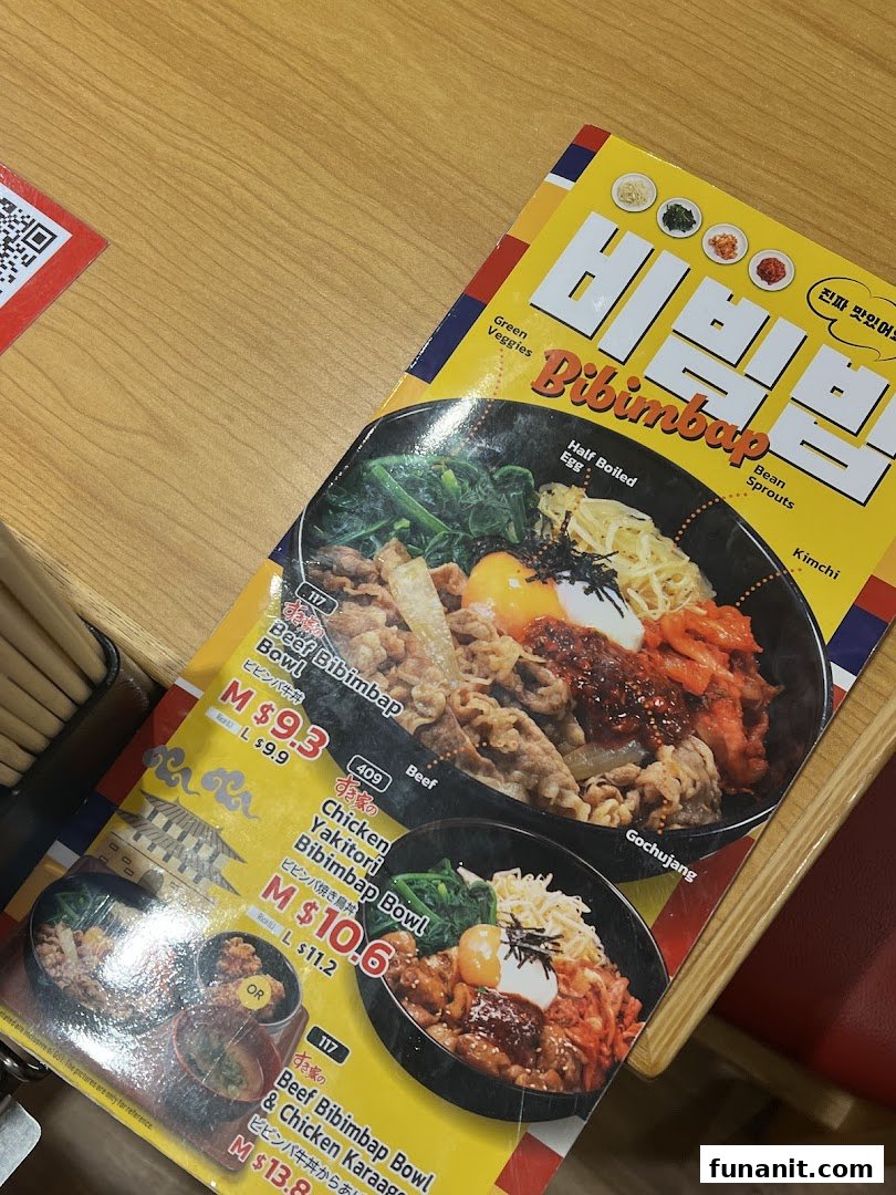 A close-up view of a Sukiya menu featuring various Bibimbap bowls with prices.