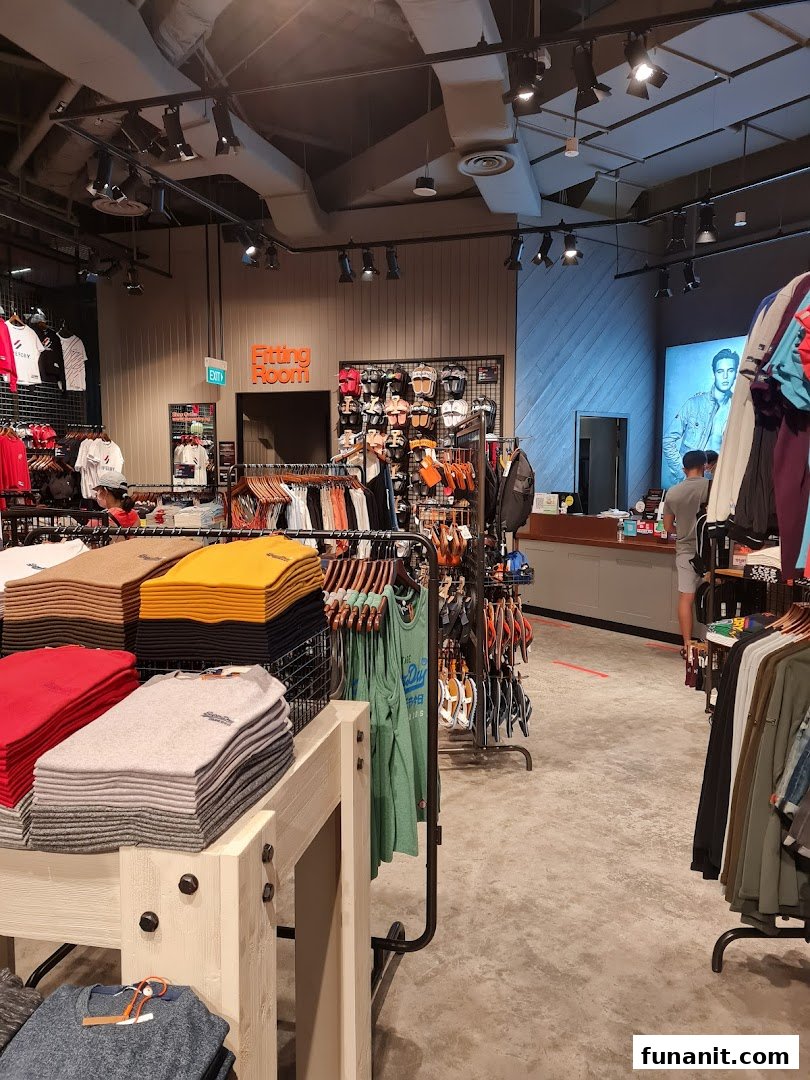 Interior view of a Superdry store, showcasing apparel, accessories, and a fitting room.