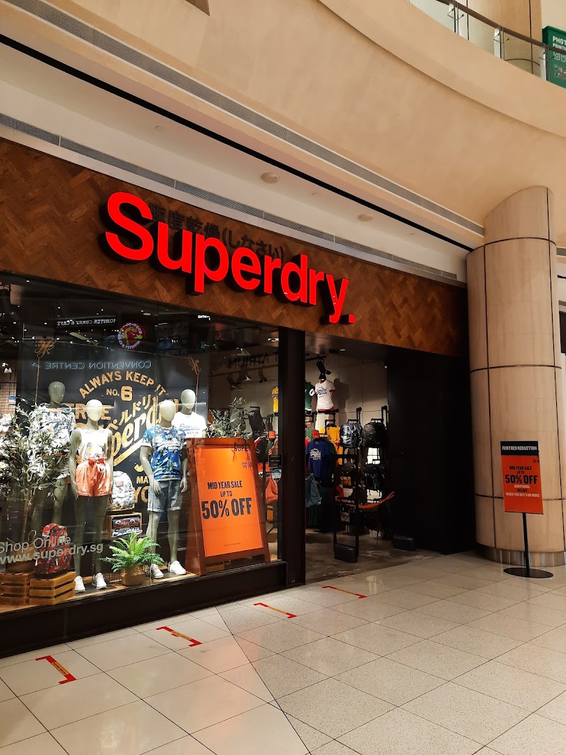 The Superdry shop front with its prominent red logo and display window showcasing apparel.