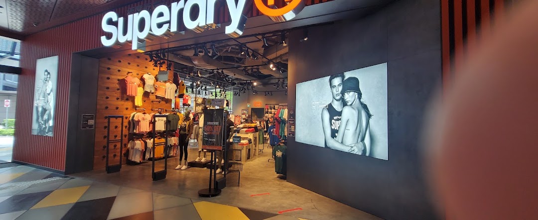 The Superdry store entrance showcasing its vibrant apparel displays and prominent branding.
