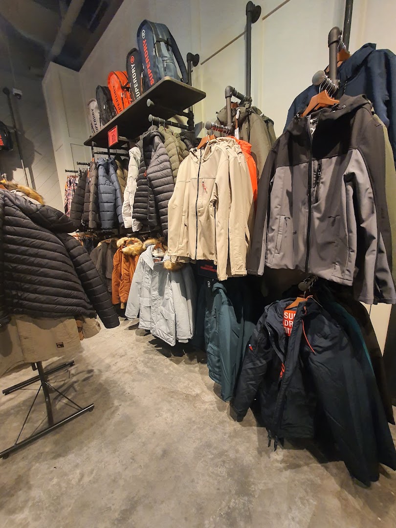 Interior view of a Superdry store showcasing a wide range of stylish jackets and bags.