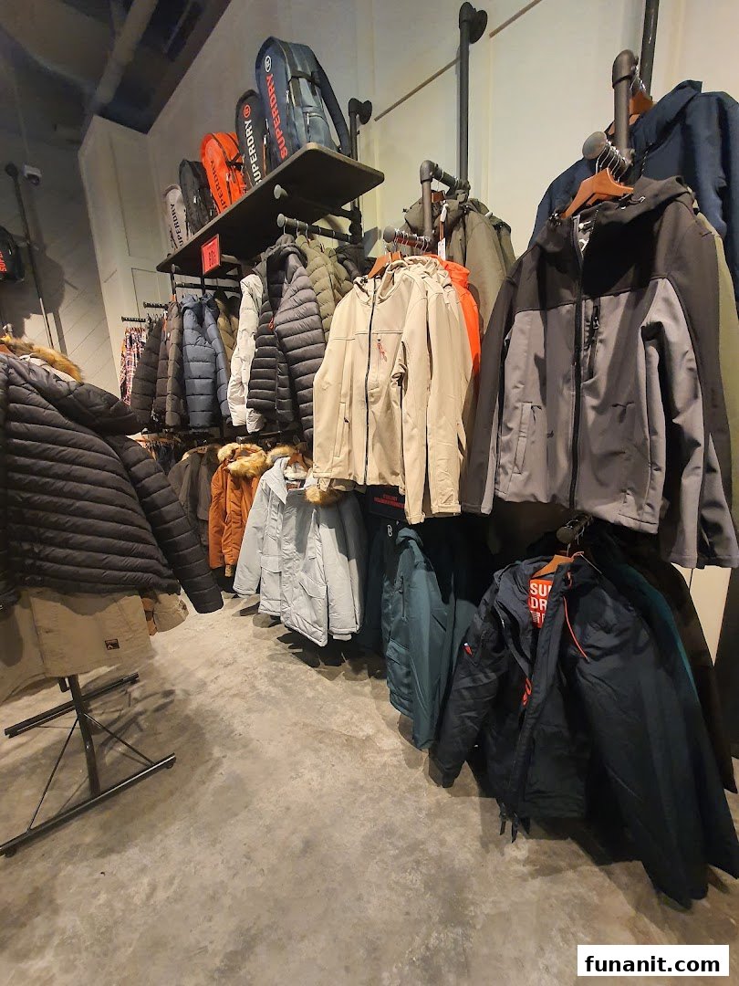 Interior view of a Superdry store showcasing a wide range of stylish jackets and bags.