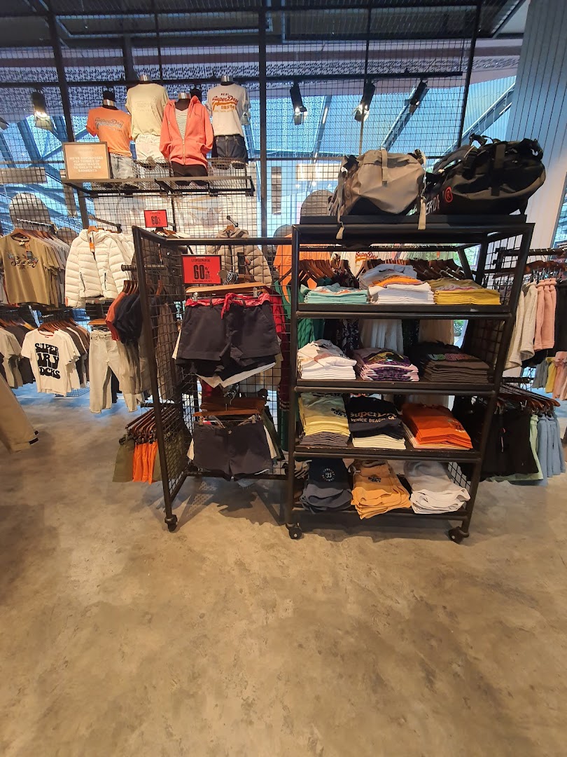 Interior view of Superdry store showcasing various apparel, accessories, and sale items on display.