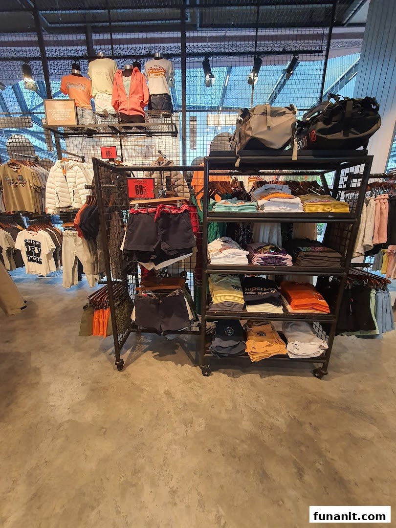 Interior view of Superdry store showcasing various apparel, accessories, and sale items on display.