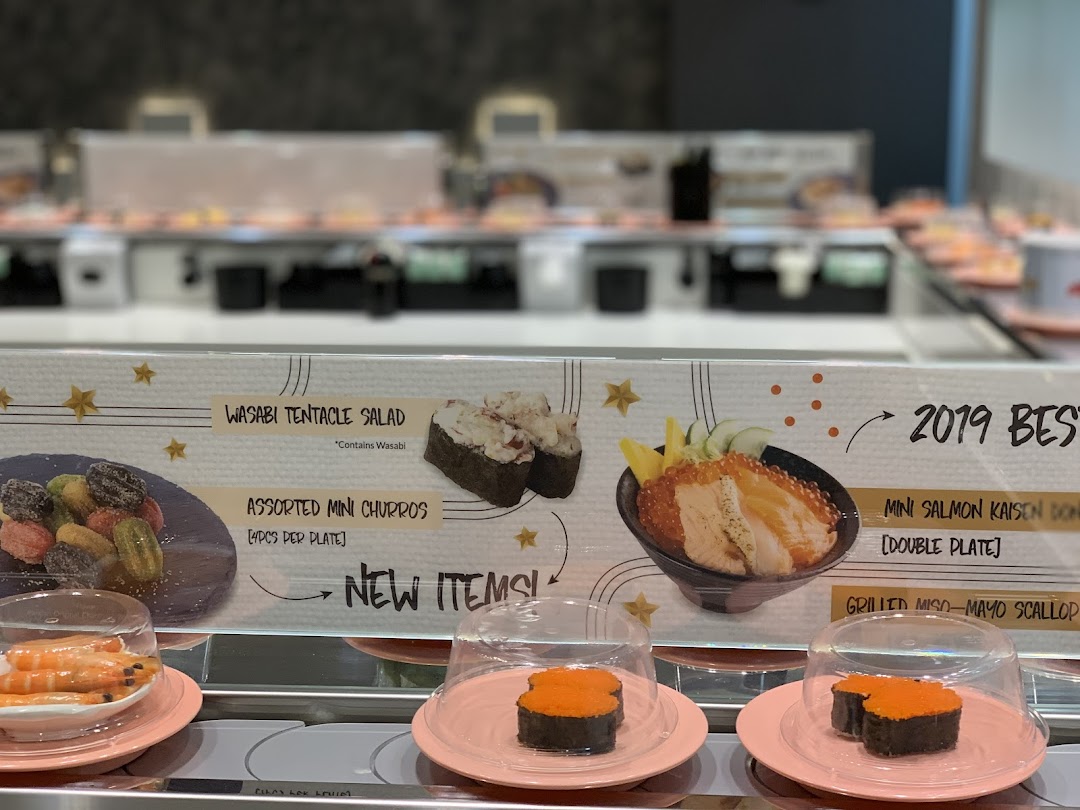 A display board showcasing new and best-selling items on a sushi conveyor belt at Sushi Express.