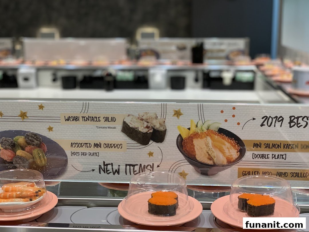 A display board showcasing new and best-selling items on a sushi conveyor belt at Sushi Express.