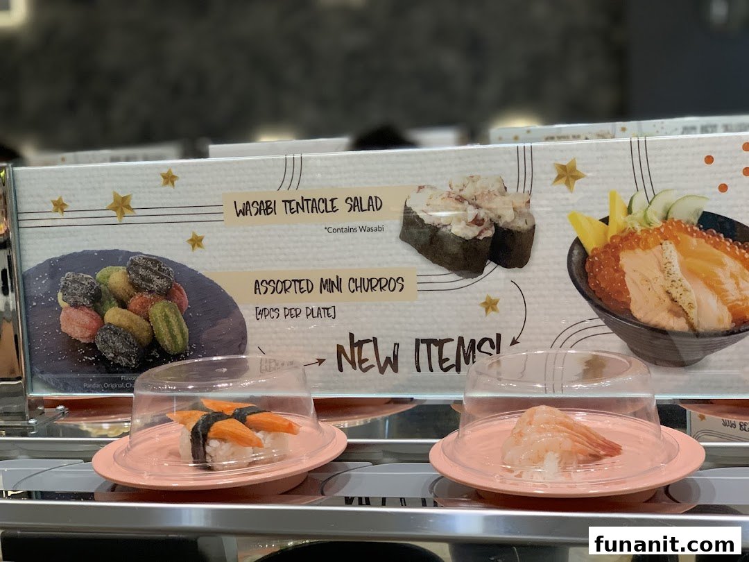 A display board showcasing new menu items and sushi on a conveyor belt at Sushi Express.