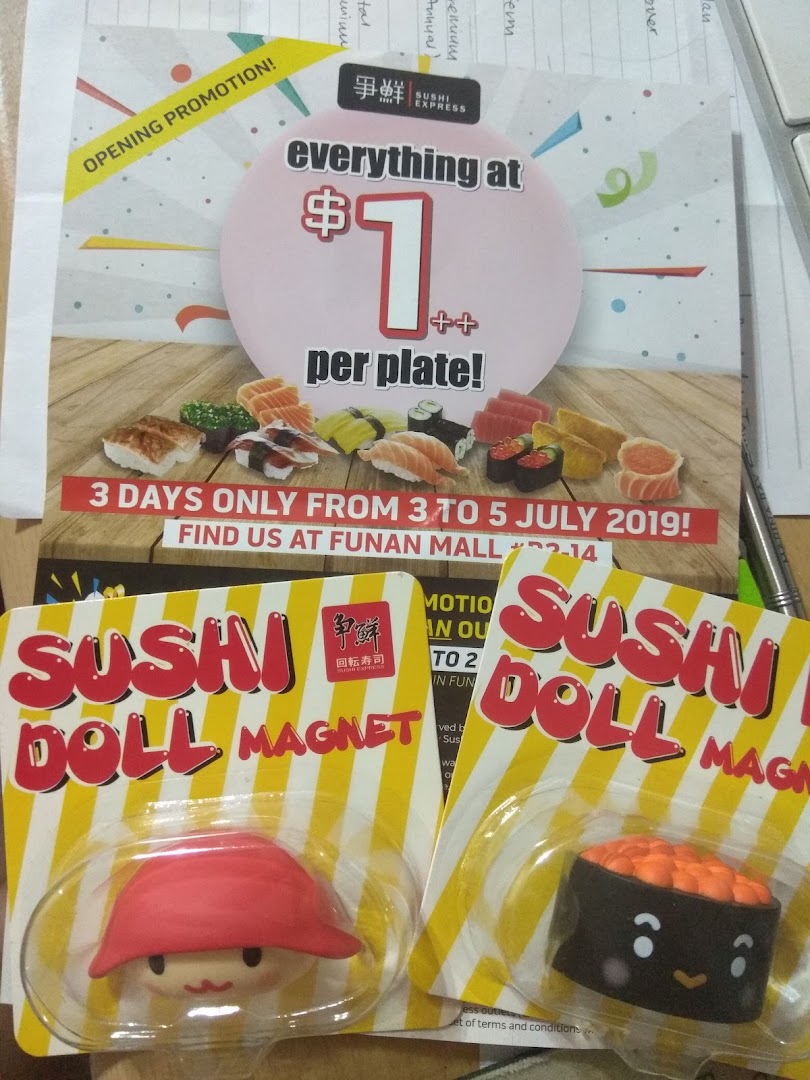 A promotional flyer for Sushi Express's $1 per plate opening promotion, alongside Sushi Doll Magnets.