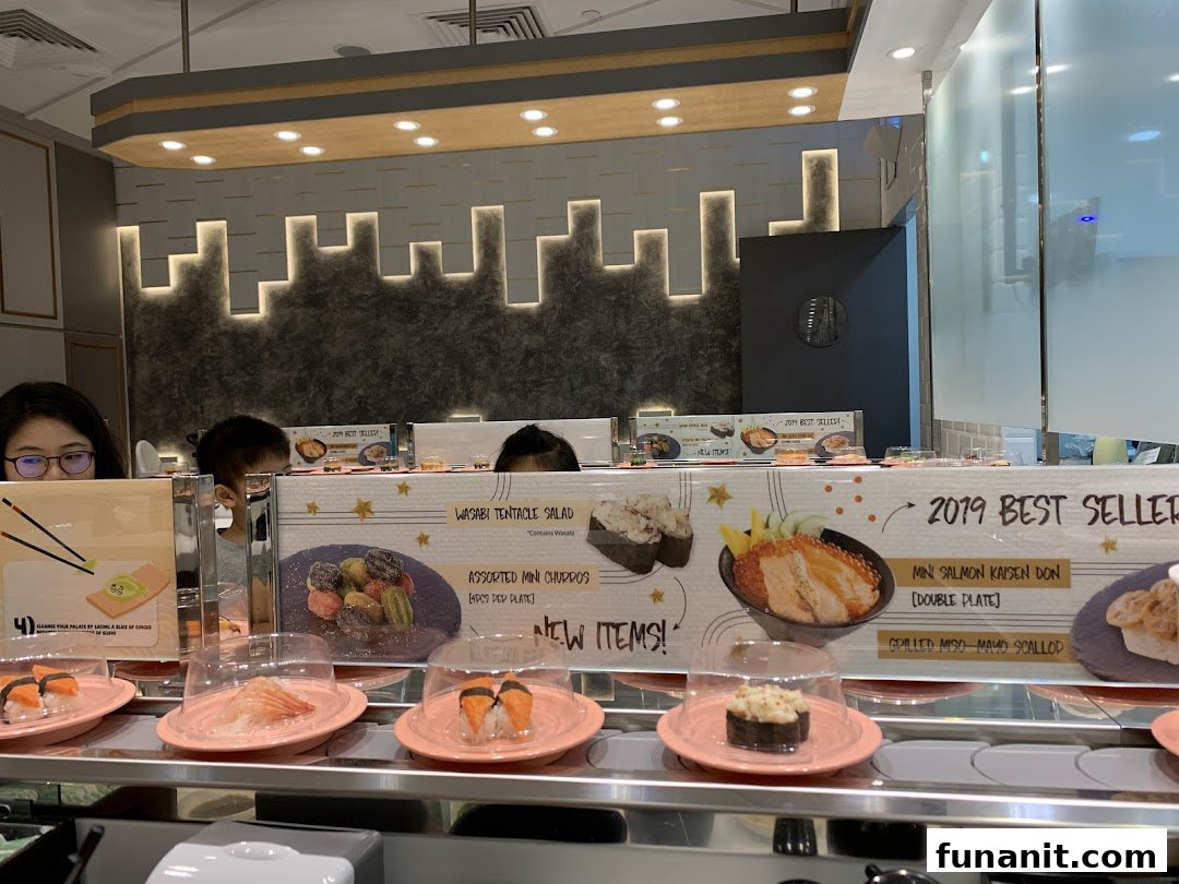 Diners enjoying sushi from a conveyor belt at Sushi Express, featuring promotional items.