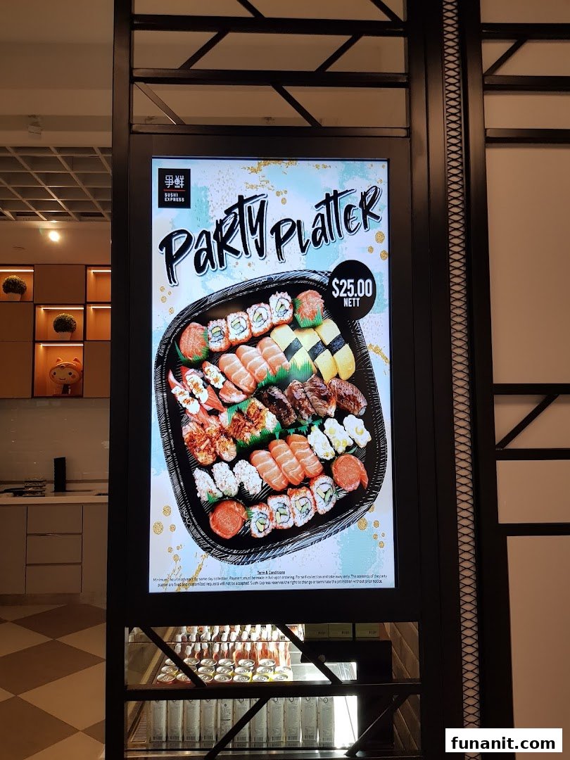 A digital display at Sushi Express Funan showcasing a Party Platter for $25.00 nett.