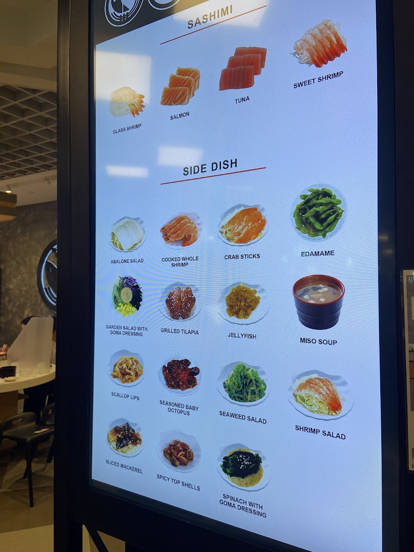 A digital menu board showcasing a variety of sashimi and side dishes with appealing images.